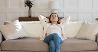 Relaxed woman on comfortable couch.