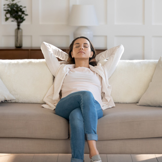 Relaxed woman on comfortable couch.